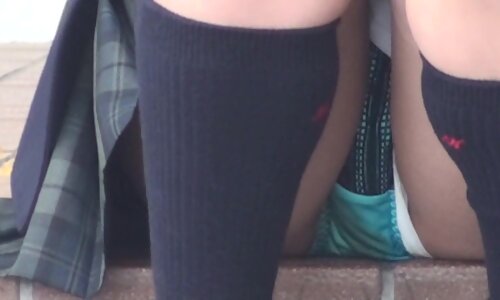 girl sitting with her legs open with skirt