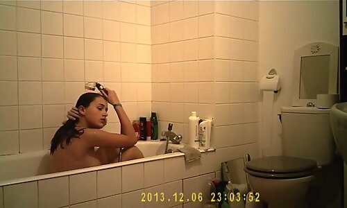 Brunette cutie enjoys a hot shower in the bathroom